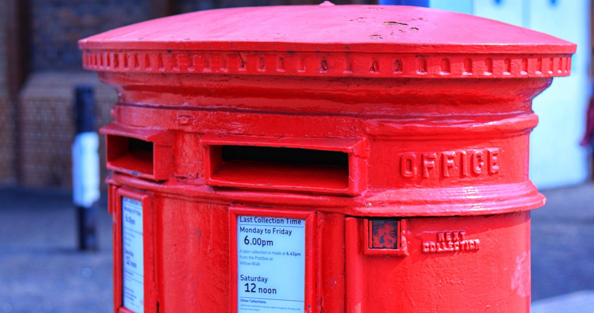 Close-up of a red postbox on a street