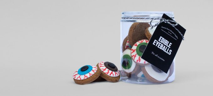 A jar of biscuits that look like flattened green and blue eyeballs