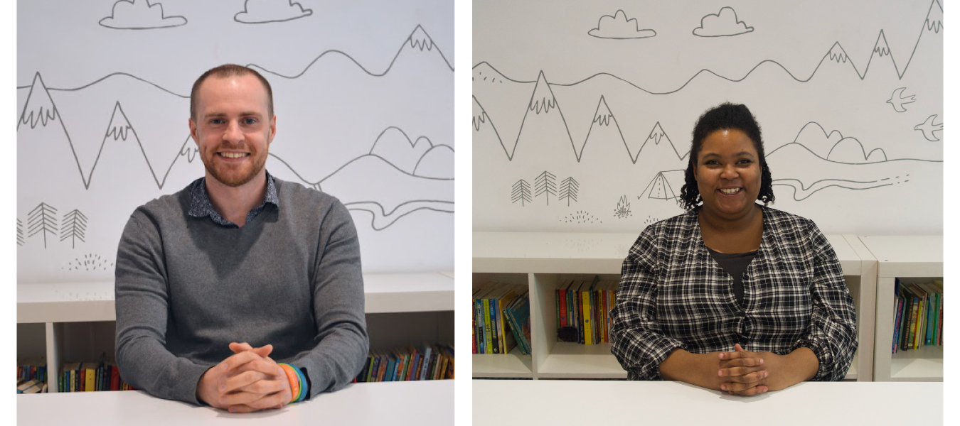 Jamie and Maya sit, smiling at a desk in the back office of the Ministry of Stories.