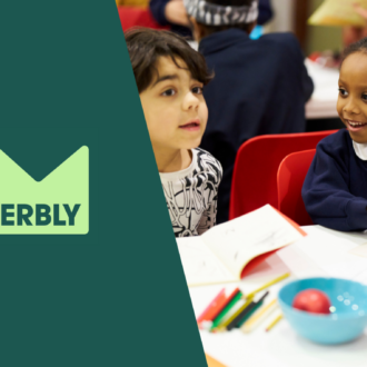 Wonderbly's logo sits alongside a picture of two young children chatting and writing together on a white table.
